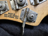Close-up of guitar tuning machine heads with "Made in San Luis Obispo California USA" text on wooden guitar headstock