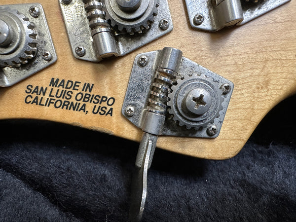 Close-up of guitar tuning machine heads with "Made in San Luis Obispo California USA" text on wooden guitar headstock