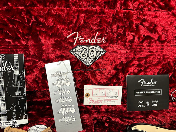 Fender 60th Diamond Anniversary guitar case interior with owner's manual, Fender hang tags, registration card, and certification on red plush lining