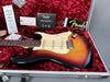 Fender Stratocaster electric guitar in sunburst finish with vintage white pickguard inside red plush-lined hard case with Fender owner's registration card and guitar tags