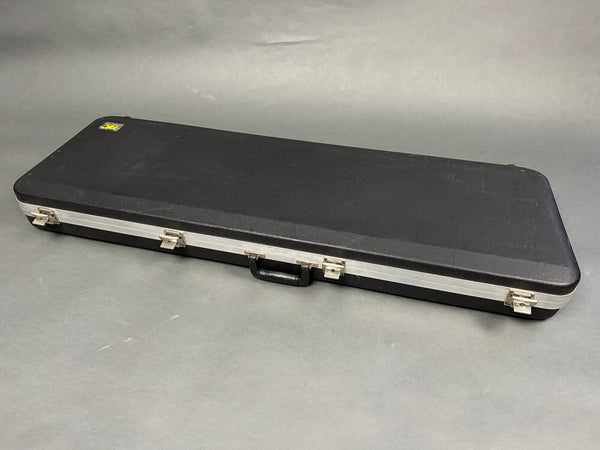 Black hard shell guitar case with silver latches and handle for electric guitar storage and transport