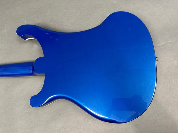 Back view of electric guitar with glossy blue finish and double cutaway body design on gray background