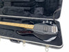 Black electric bass guitar with maple neck and chrome hardware in black plush-lined hard case, four-string bass guitar case interior