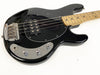 Black electric bass guitar with maple fretboard, chrome bridge, and control knobs on white background