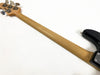 Maple neck of electric bass guitar with chrome tuning pegs on white background