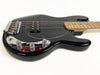 Black electric bass guitar with maple neck, chrome bridge, and control knobs on white background