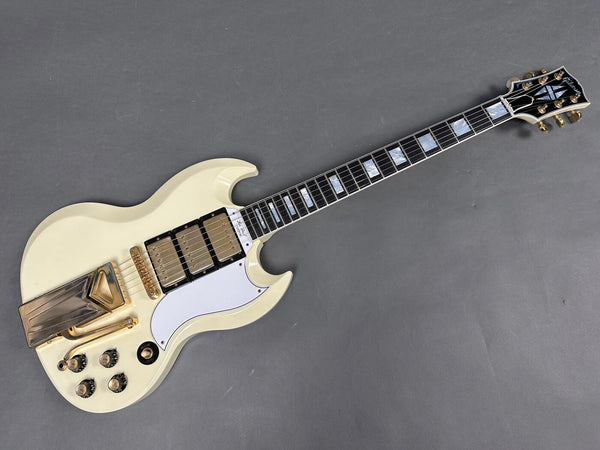 Vintage Gibson SG electric guitar with white finish, triple gold humbucker pickups, white pickguard, and gold hardware on gray background