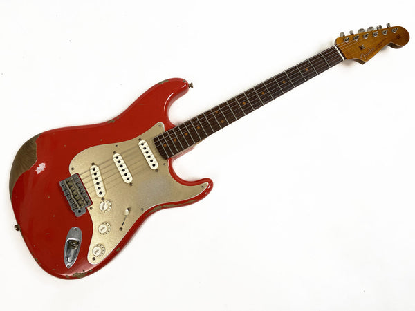 Vintage red Fender Stratocaster electric guitar with worn finish, gold pickguard, three single-coil pickups, rosewood fretboard, and maple headstock on white background