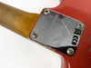 Close-up of Fender Custom Shop Limited Edition guitar neck plate with serial number CZ533782 on red electric guitar body with four screws and wood neck visible