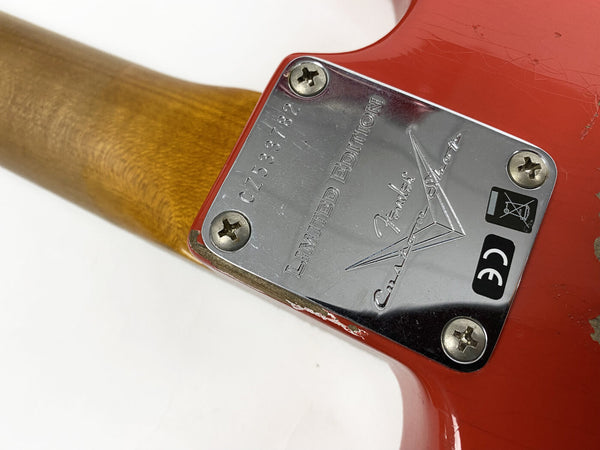 Close-up of Fender Custom Shop Limited Edition guitar neck plate with serial number CZ533782 on red electric guitar body with four screws and wood neck visible
