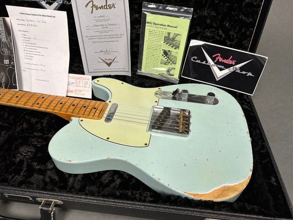 Fender Classic Relic S-1 Telecaster guitar in light blue with worn finish displayed in black plush guitar case showing Fender Custom Shop certificate, operation manual, and pre-sales checklist.