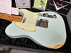 Fender Custom Shop vintage-style Telecaster electric guitar in light blue finish with worn relic details, maple neck, and cream pickguard displayed in plush black guitar case with Fender Custom Shop paperwork and authenticity certificates.