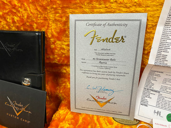 Fender Custom Shop Certificate of Authenticity for 60 Stratocaster Relic guitar with serial number R95014 dated 08/25/2018 on orange plush guitar case lining with Fender Custom Care wallet and hardware specifications sheet.
