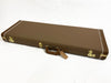 Brown Fender hard guitar case with gold latches and leather handle on white background