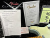 Fender Custom Shop guitar authenticity certificate, Coffee House Guitars pre-sales checklist for Fender S1 Telecaster, instruction manual, and part of a light blue Fender Telecaster guitar body on black background