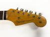 Close-up of Fender Stratocaster guitar headstock with six tuning pegs and "Original Contour Body" logo on natural wood finish