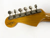 Close-up of Fender Custom Shop guitar headstock with vintage tuning pegs on natural wood finish neck