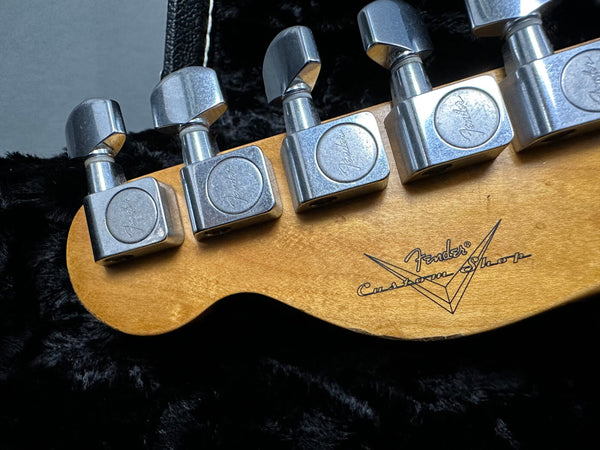 Close-up of Fender Custom Shop electric guitar headstock showing tuning pegs and wood grain detail on maple neck
