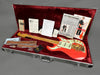 Burns Shadows Custom Signature electric guitar in bright red finish with maple neck and gold hardware, displayed in open hardshell case with certificate of authenticity, owner's manual, leather guitar strap, and maintenance accessories on burgundy velvet interior
