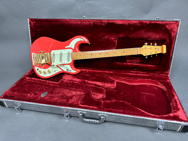 Red Burns electric guitar with maple neck and gold hardware in open black textured guitar case with red velvet interior lining