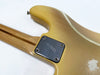 Vintage yellow electric guitar body with maple neck and a metal neck plate featuring an engraved logo, showing worn finish and scratches