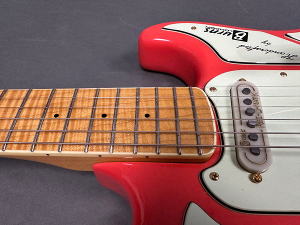 Close-up of red Burns London electric guitar neck and body with rosewood fretboard and single coil pickup labeled Rez-o-matik
