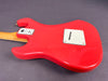 Back view of red electric guitar body with white plastic cavity cover and neck plate showing "The Shadows Cust. Shop Edition" badge on gray background