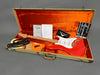Red Fender Stratocaster electric guitar with maple neck in open tweed hard case with orange interior, including Fender Certificate of Authenticity, owner’s manual, strap, and accessories