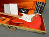 Fender Custom Shop electric guitar in Fiesta Red finish with maple neck, white pickguard, gold hardware, certified authenticity and owner's manual in vintage tweed hard case with orange plush interior