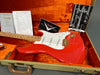 Red Fender Stratocaster electric guitar with maple neck and gold hardware in orange plush-lined tweed guitar case with Fender certificate of authenticity, owner's manual, and Coffee House Guitars pre-sales checklist