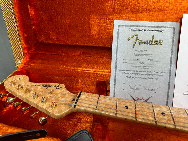 Fender 1956 Stratocaster NOS guitar headstock with gold tuning pegs in orange plush-lined guitar case with Fender certificate of authenticity