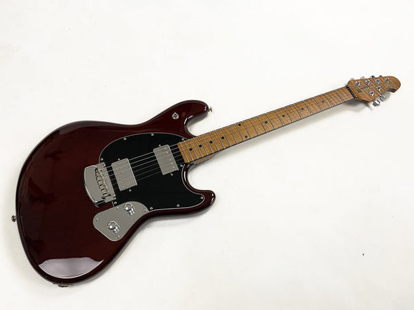 Solid body electric guitar with dark cherry finish, black pickguard, maple fretboard, and dual humbucker pickups on white background