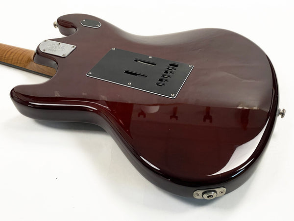 Rear view of dark red electric guitar body with black backplate and maple neck at Coffee House Guitars