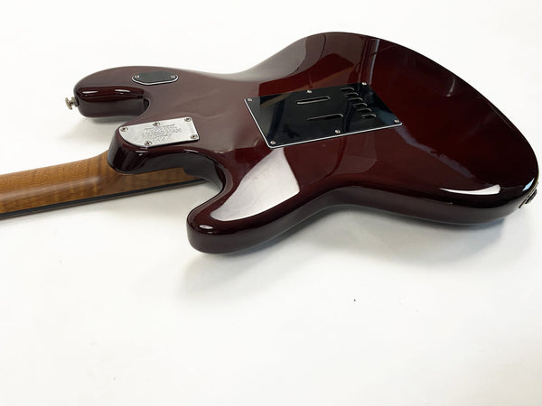 Back view of dark red electric guitar body with maple neck and metal neck plate on white background