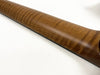 Close-up of flamed maple wood guitar neck with smooth satin finish on white background