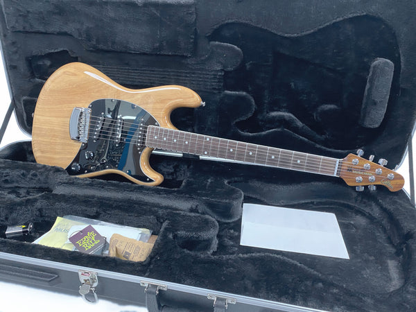 Music Man Cutlass natural finish electric guitar in black-lined hard case with accessories and Ernie Ball strings