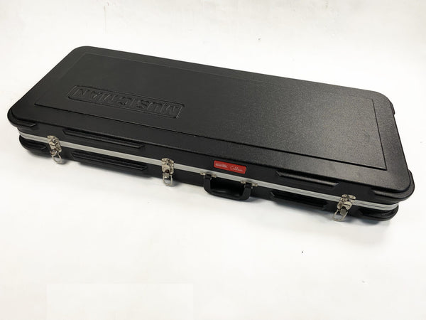 Black hard shell rectangular Musicians Gear guitar case with metal latches and handle on white background