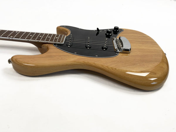 Natural wood finish electric guitar with black pickguard and chrome bridge, six-string guitar with rosewood fretboard and three single-coil pickups on white background