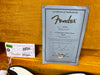 Fender Certificate of Authenticity for 57 Stratocaster Closet Classic with serial number R71587 inside vintage orange guitar case next to Fender RoHS inspection tag and part number label on electric guitar body