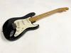 Black Fender Stratocaster electric guitar with maple neck and white pickguard on white background