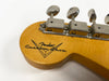 Close-up of Fender Custom Shop guitar headstock with vintage tuners and logo on natural wood finish
