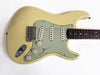 Vintage cream electric guitar with three single-coil pickups and rosewood fretboard on white background
