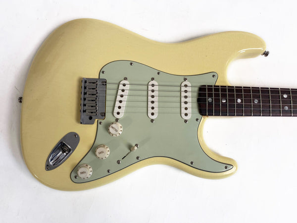 Vintage cream electric guitar with three single-coil pickups and rosewood fretboard on white background