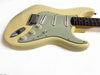Vintage cream electric guitar with three single-coil pickups and mint green pickguard on white background