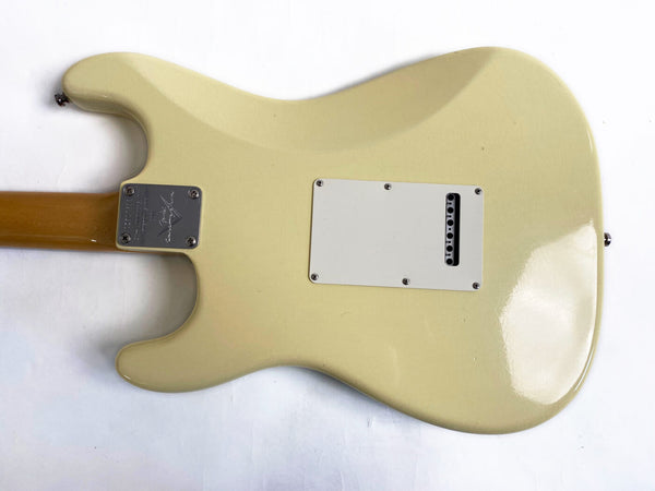 Back view of vintage cream electric guitar body with white backplate and metal neck plate screws on white background