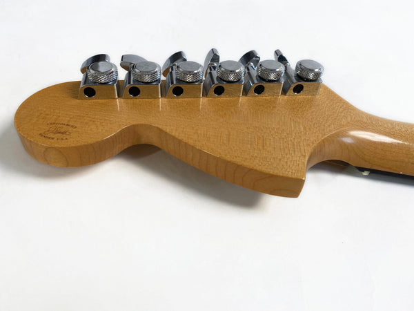 Close-up of Fender Custom-Built guitar headstock with six chrome tuning pegs on natural wood finish neck
