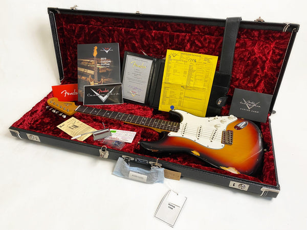 Fender Custom Shop 2019 sunburst electric guitar with rosewood fretboard in a black hard case with red plush interior, includes Fender certificate of authenticity, custom care booklet, shop floor traveler sheet, tremolo arm, and Fender warranty card.