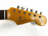 Vintage Fender Stratocaster guitar headstock with tuning pegs and original contour body decal on white background