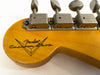 Close-up of vintage Fender Custom Shop guitar headstock with vintage tuning machines and Fender logo on natural wood finish