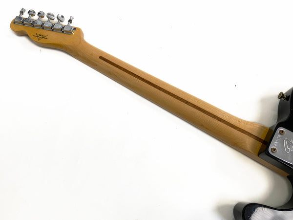 Back of Fender electric guitar maple neck with tuning pegs and skunk stripe on white background